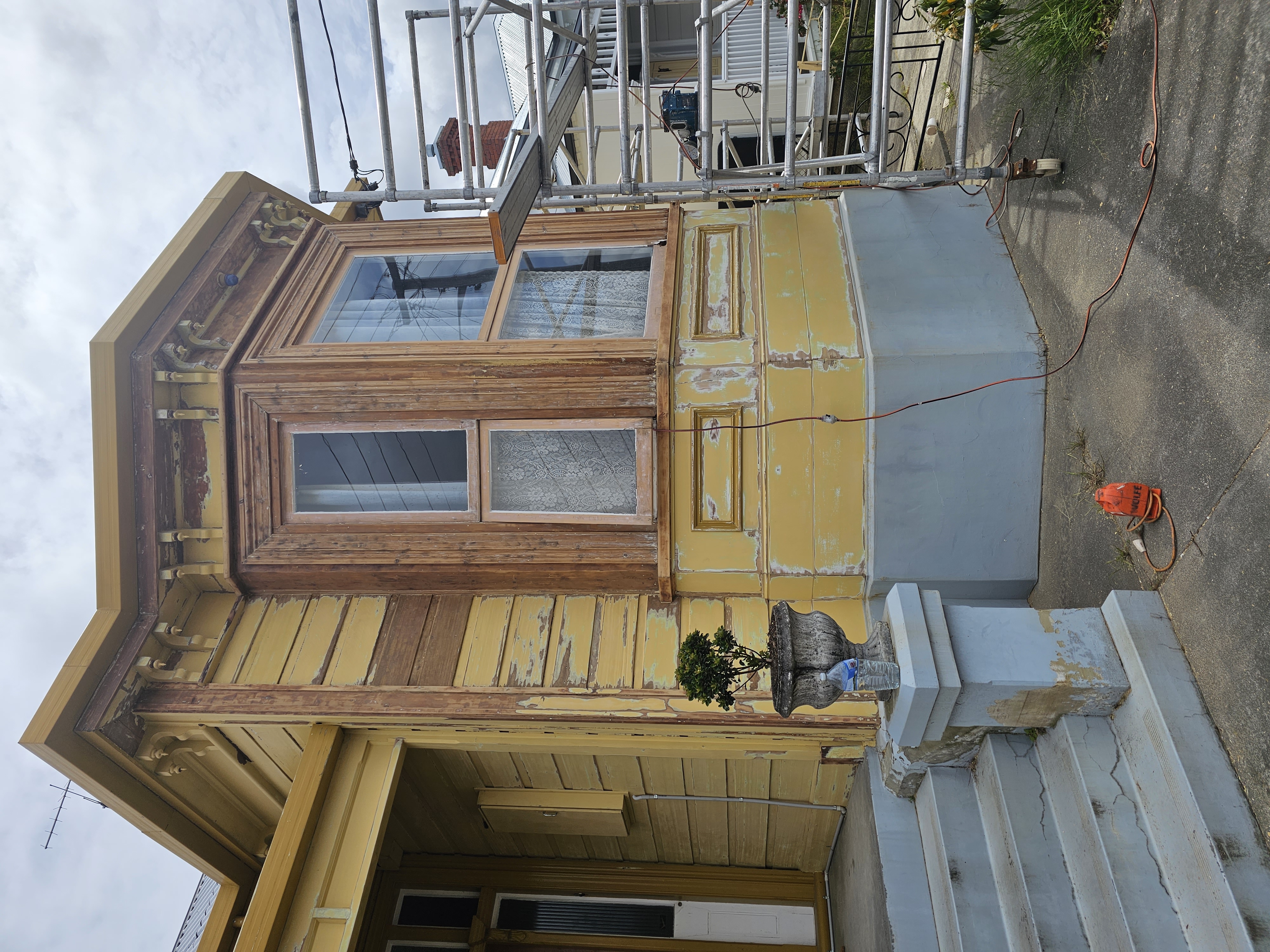 Extensive weatherboard preparation and coating removal during exterior restoration project in Hobart.